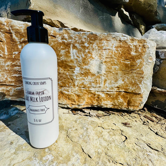 Lotion bottle labeled 'Farm Fresh' on a rocky surface