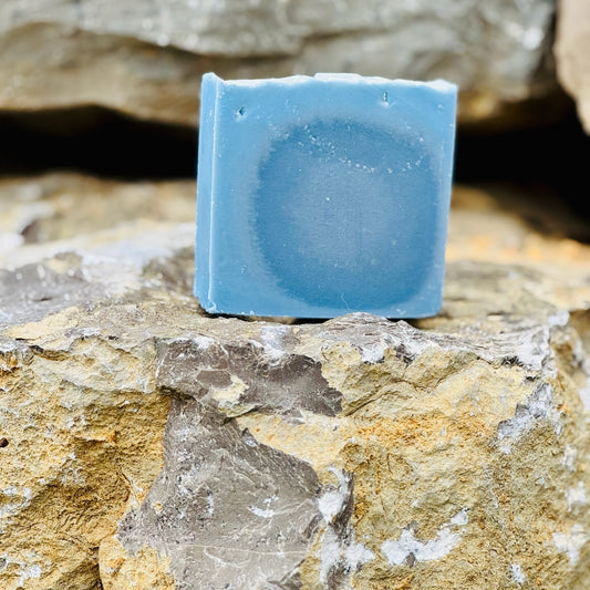 Blue soap bar on a rocky surface