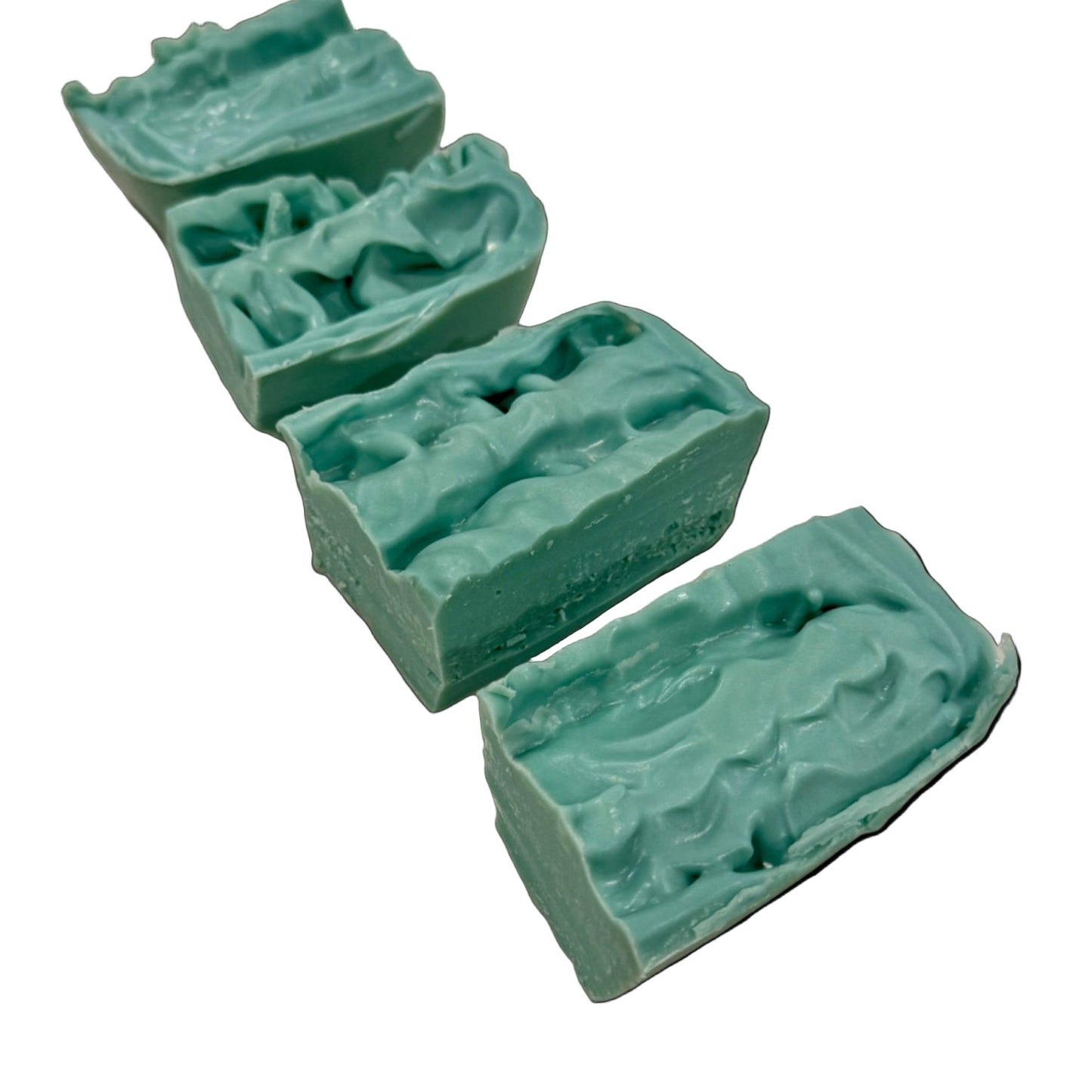 Three green soap bars with a textured surface on a marble countertop.